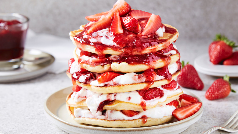 Pancake stack with strawberries and yogurt between layers