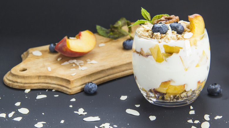 Blueberry, peach and walnut parfait in a glass jar