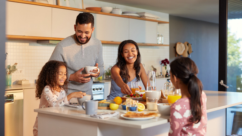 Happy family enjoying breakfast together in the kitchen