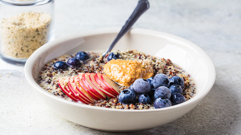 Quinoa porridge with apple, blueberry, and nut butter