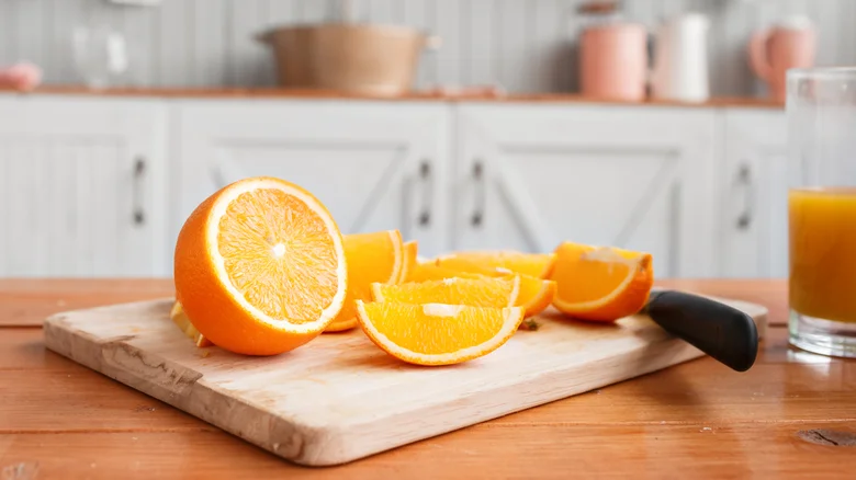 sliced oranges on a wooden cutting board