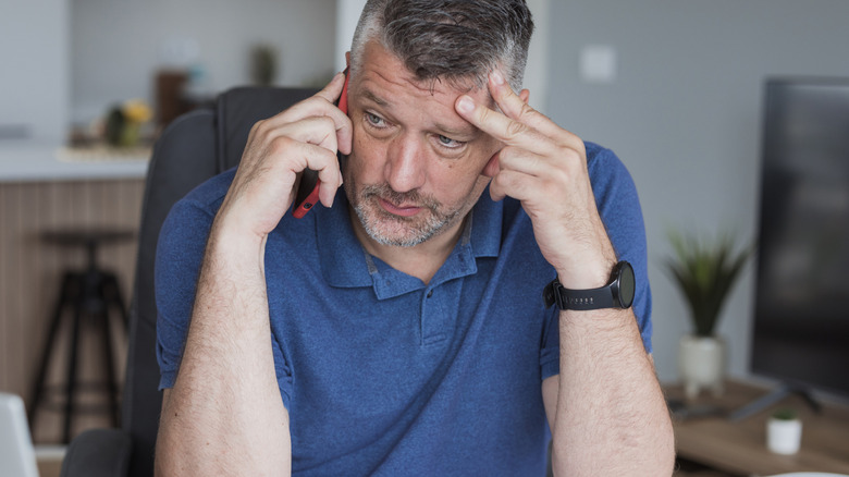 Stressed middle-aged man working from home