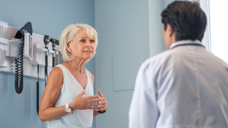 Adult woman talking with her doctor at a routine medical appointment