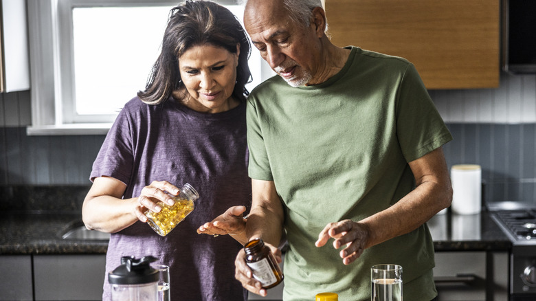 Senior couple taking their medications at home