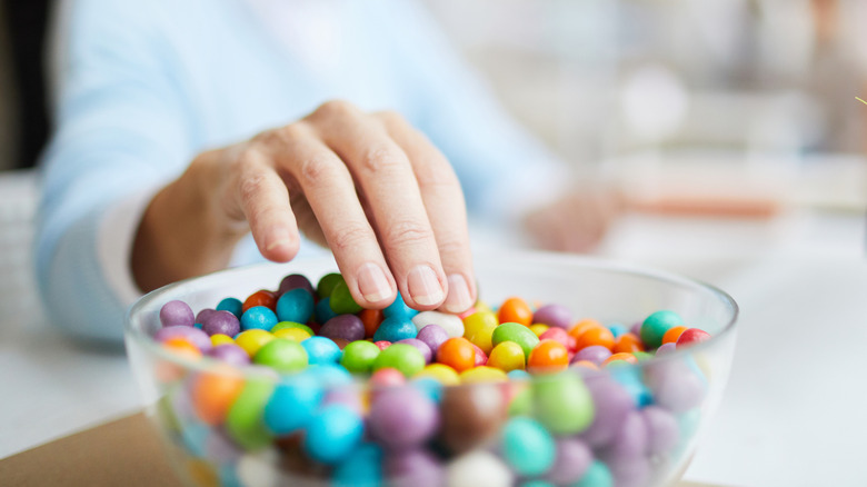 Middle-aged woman eating sweet beans at work