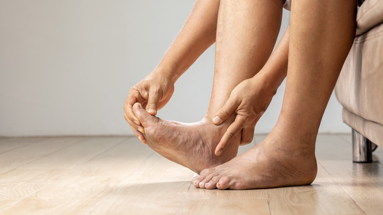person holding flexed foot