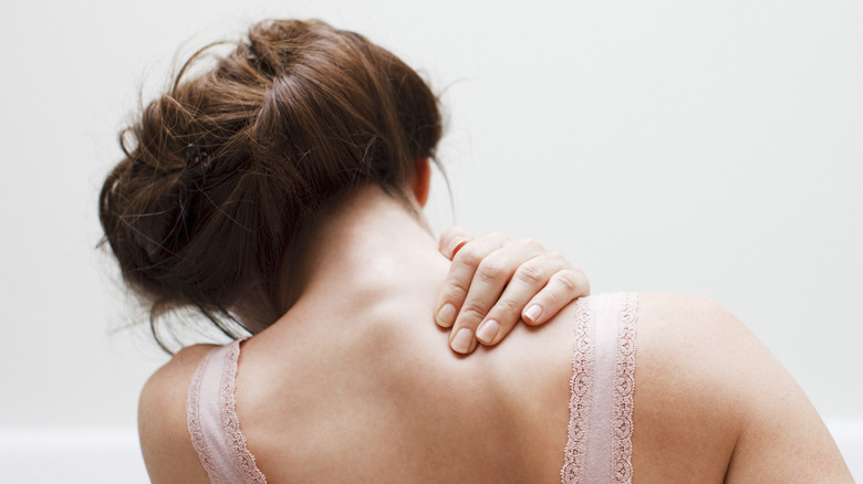 Woman rubbing a sore shoulder