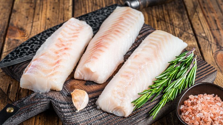 cod fillets on wooden board
