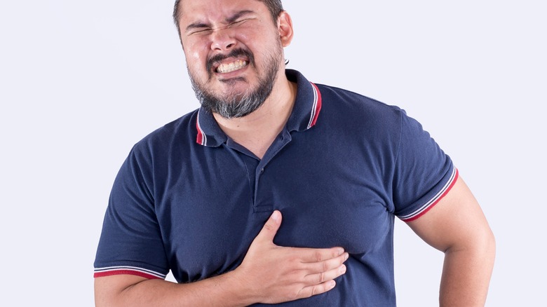 man in blue shirt with heartburn