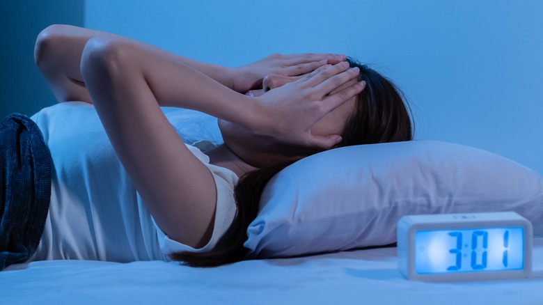 woman waking insomnia bed