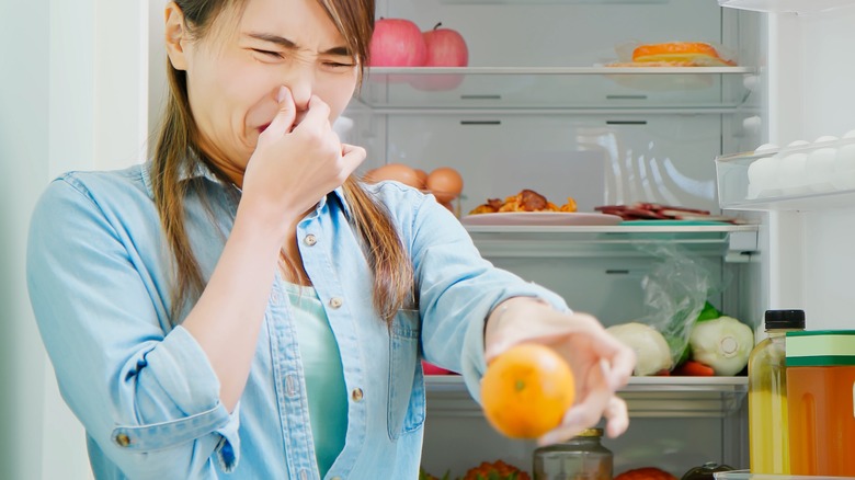 woman throwing away old food