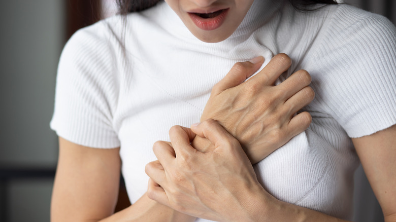Woman in pain holding her breast