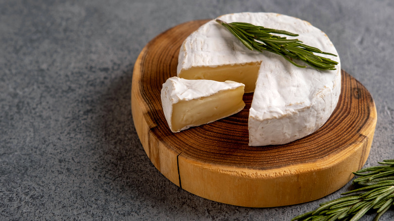 camembert cheese on wooden block