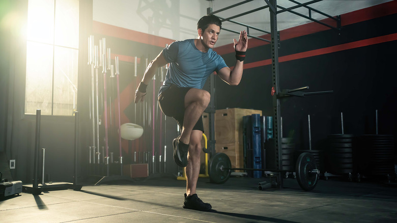 Man performing a skipping exercise in gym