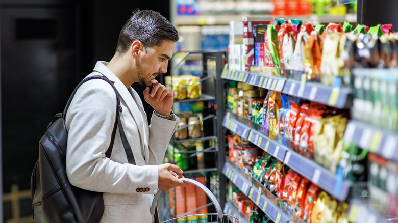 man in grocery store aisle