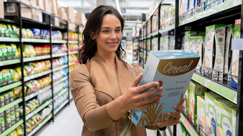 woman looking at cereal box