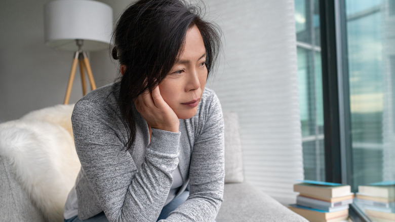 woman thinking resting chin on hand