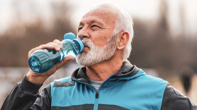 older man drinking water