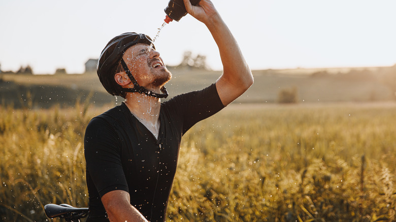 cyclist dousing self with water