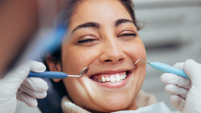 dental provider examining the teeth of a female 