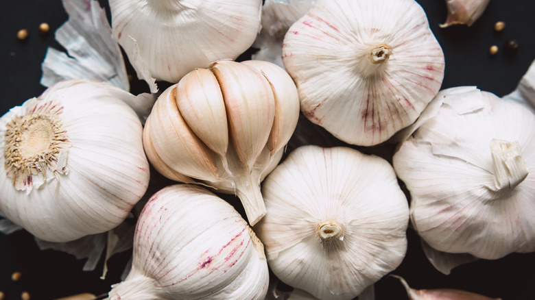 garlic bulbs on black background