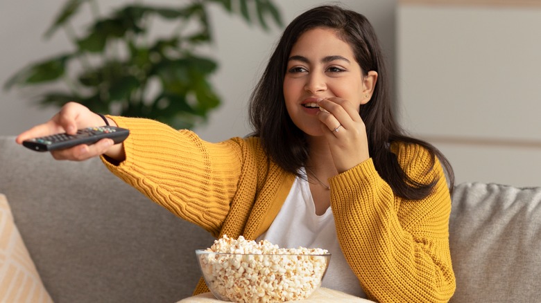 Young woman munching on popcorn