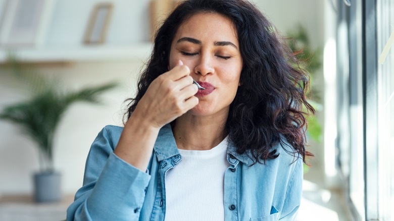 Woman smiling while eating food