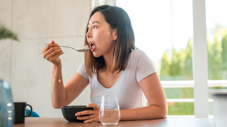 Woman eating at her table