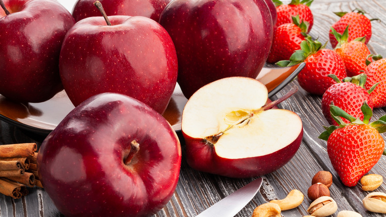 red delicious apples with nuts and strawberries