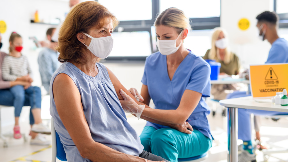 Woman giving COVID-19 vaccination