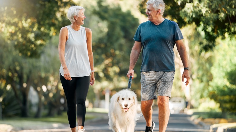 Laughing couple walking in park