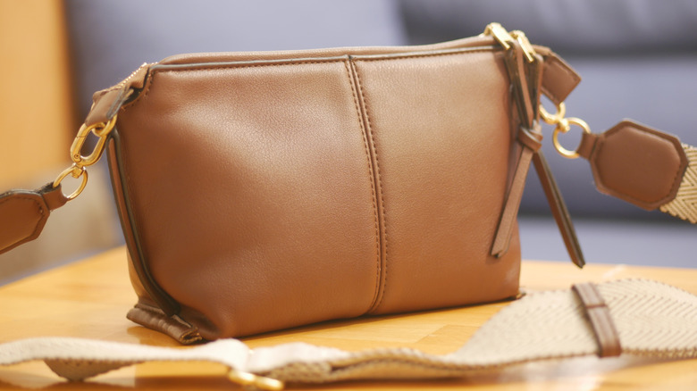 Stylish brown handbag sitting on a wooden table