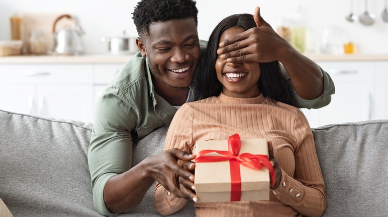 a husband giving his wife a present 