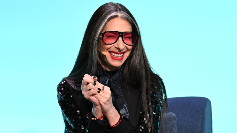 Stacy London at a public event sitting on a couch