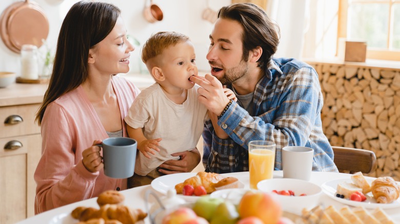 Parents feeding kid