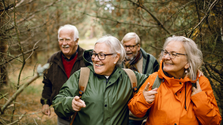 older hikers in the woods in the colder months