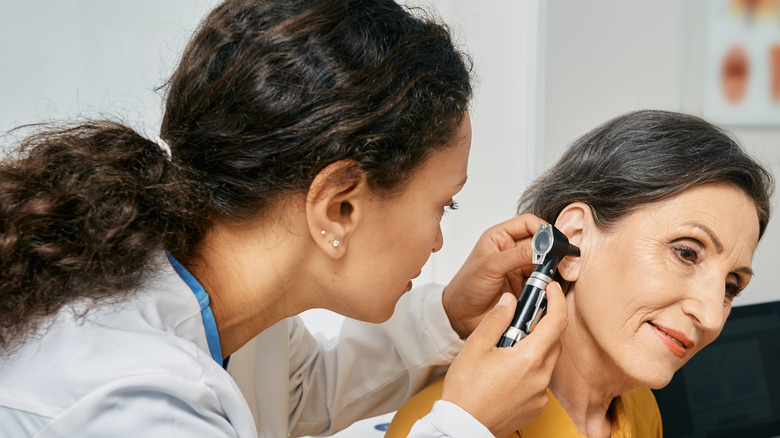 woman having ear examed