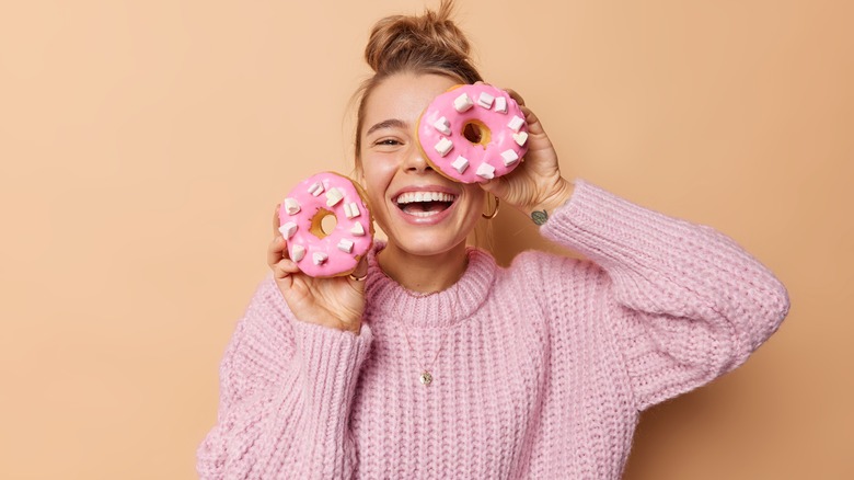 woman holding doughnuts