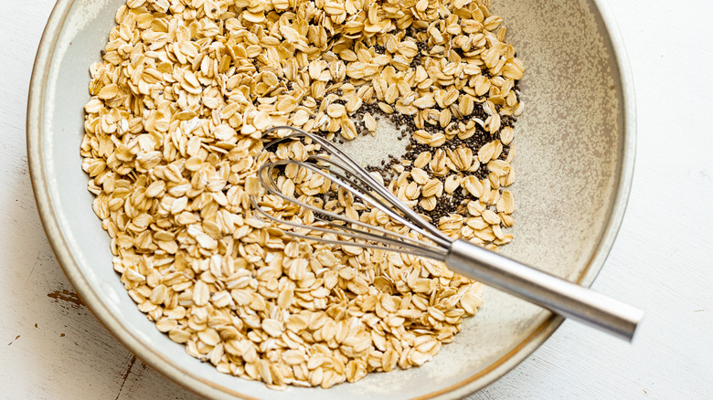 Whisking oats and chia seeds in bowl