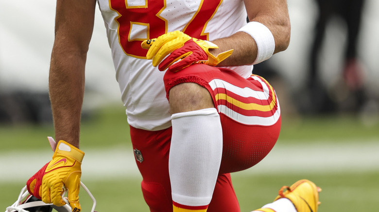 Travis Kelce with his hand on his knee during a 2023 game