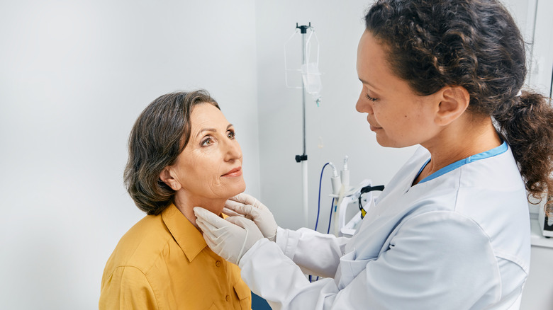 Doctor examining patient's lymph nodes