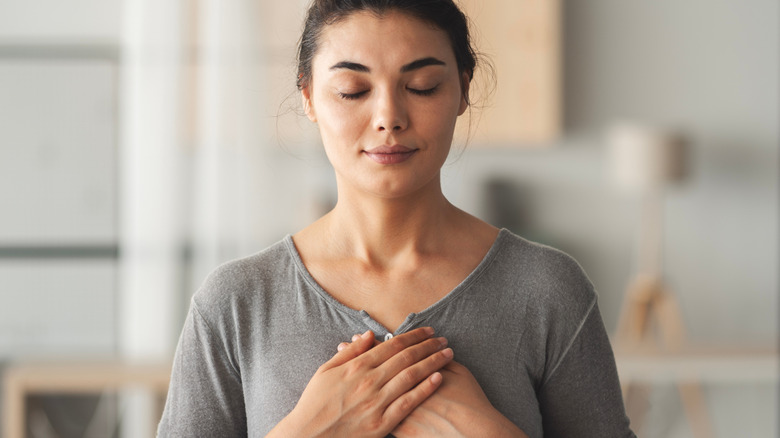 Woman with her hands on her heart
