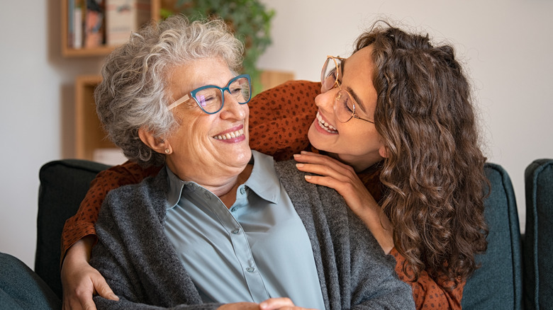 A senior woman and a younger woman laughing