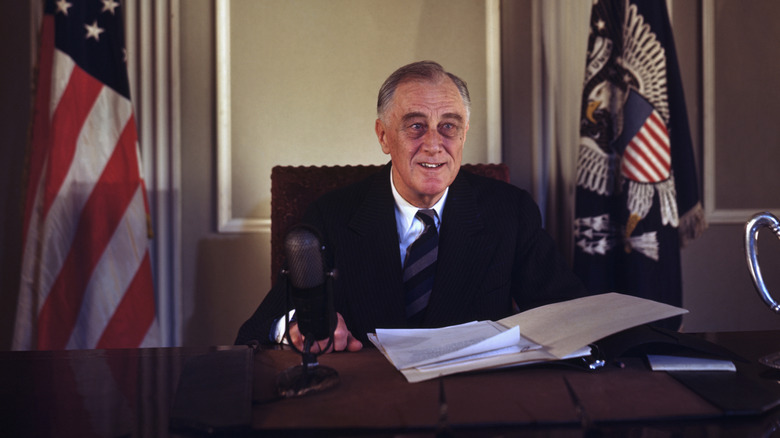 Franklin D. Roosevelt in color sitting behind the desk.