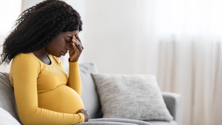 pregnant woman experiencing a headache