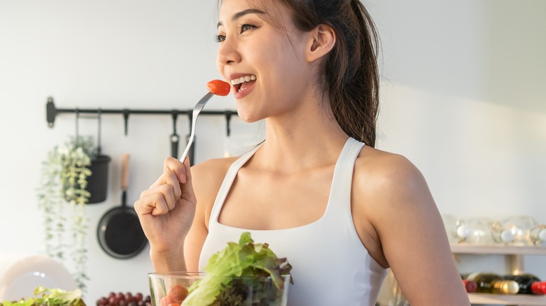 young woman happily eating