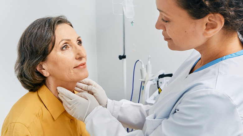 doctor checking a patient's neck enlargement