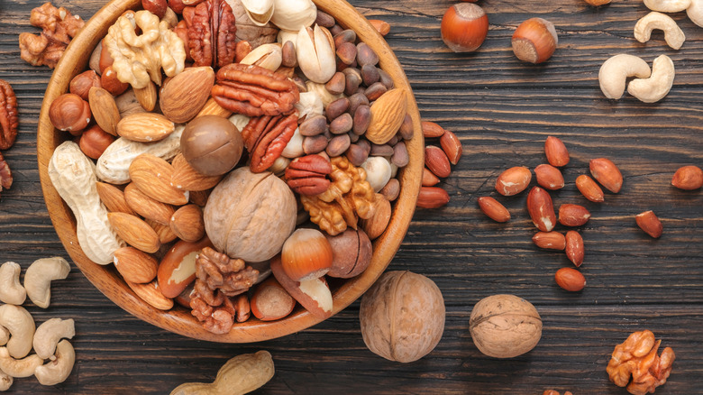 assorted nuts in bowl and on table