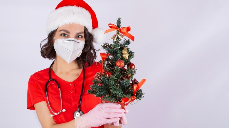 Doctor with a mini Christmas tree