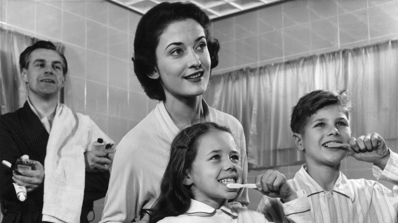 A family brushing their teeth